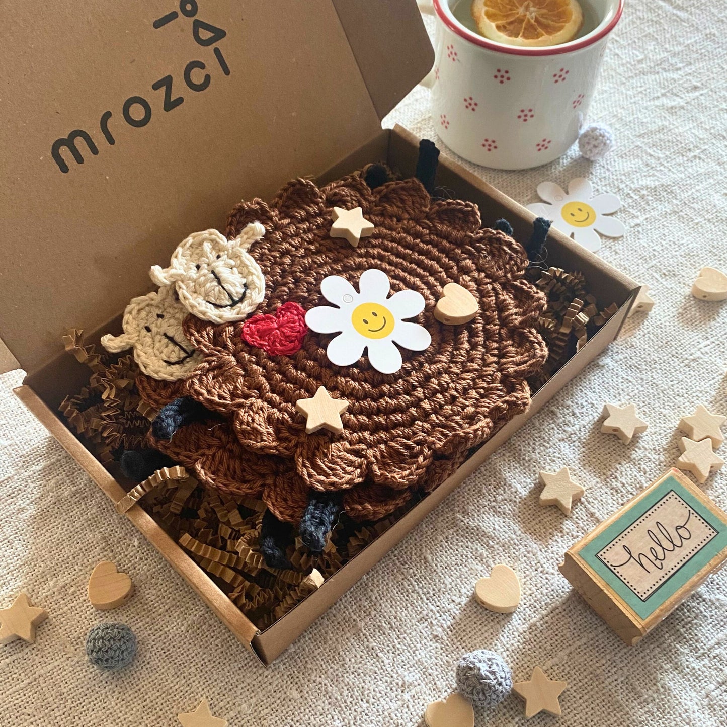 Brown crochet sheep mug rugs by Mrozci presented in an open branded gift box