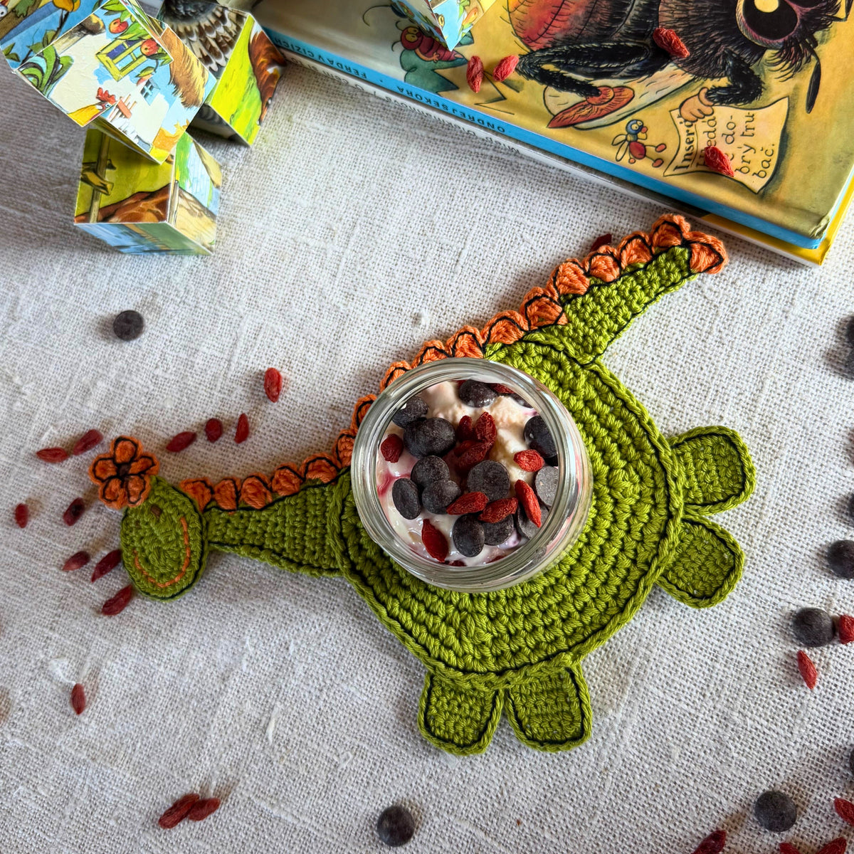 Full green dinosaur coaster with a jar placed on its round body