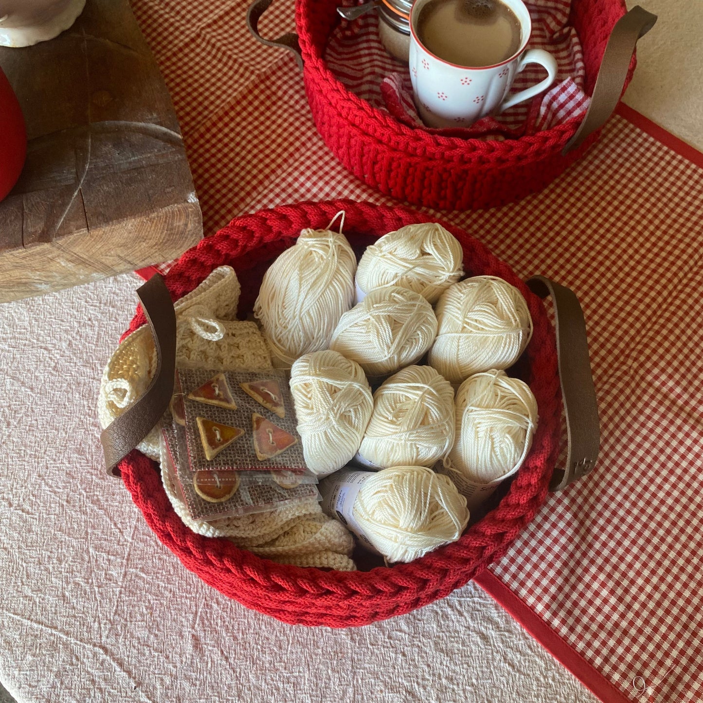 Red crochet storage bin with yarn balls 