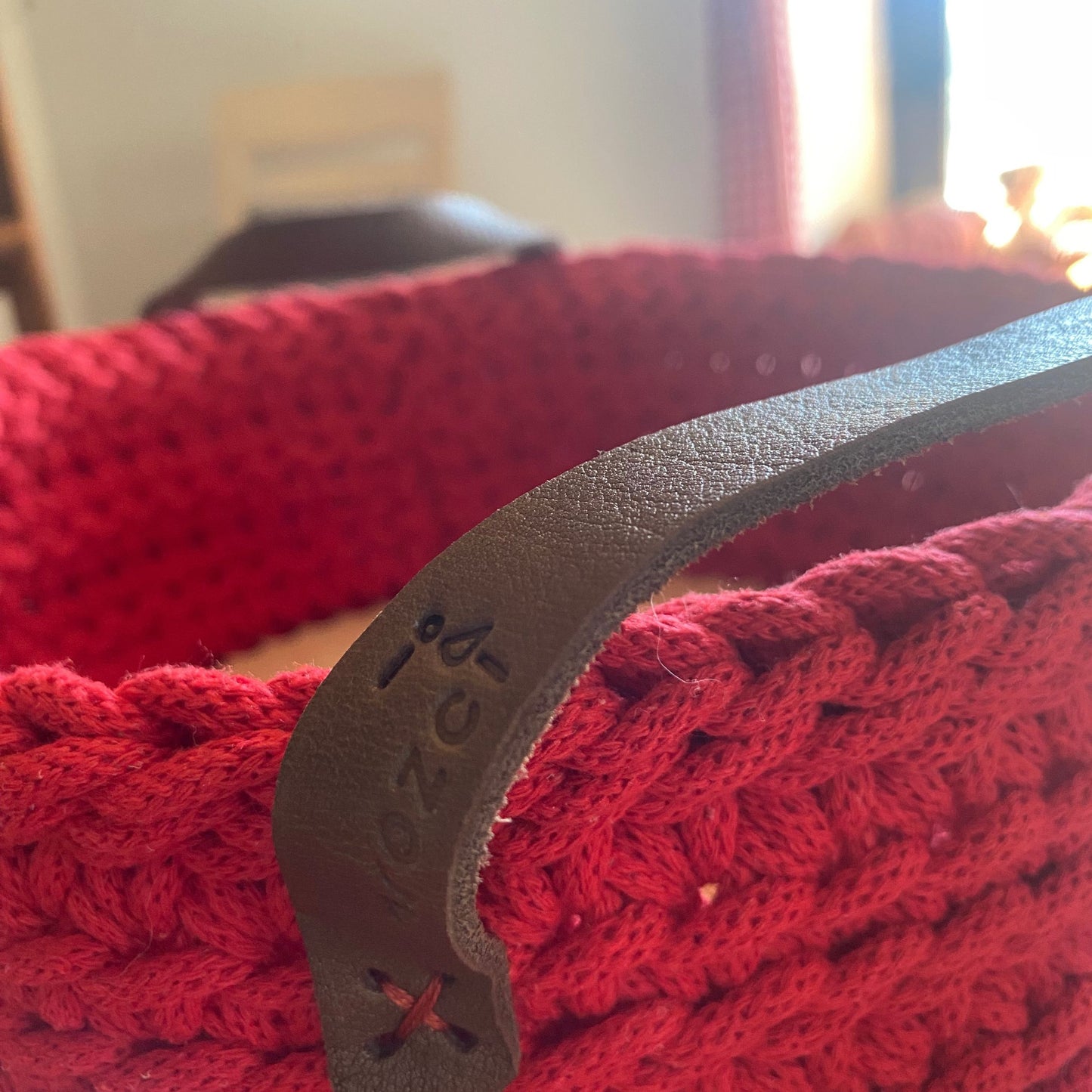 Handmade cotton cord basket, detail of leather handles