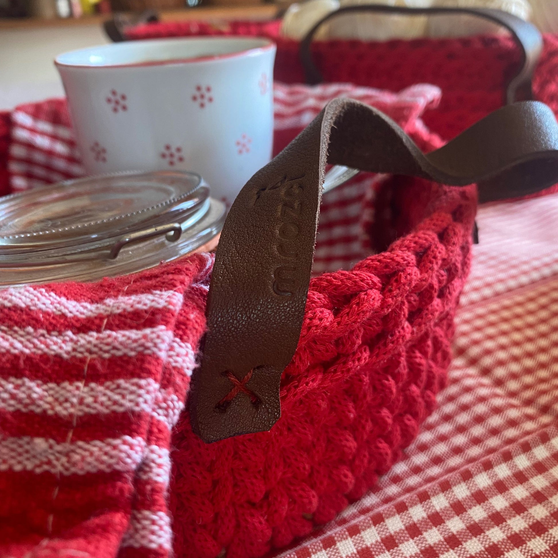 Handmade cotton cord basket, detail of leather handles