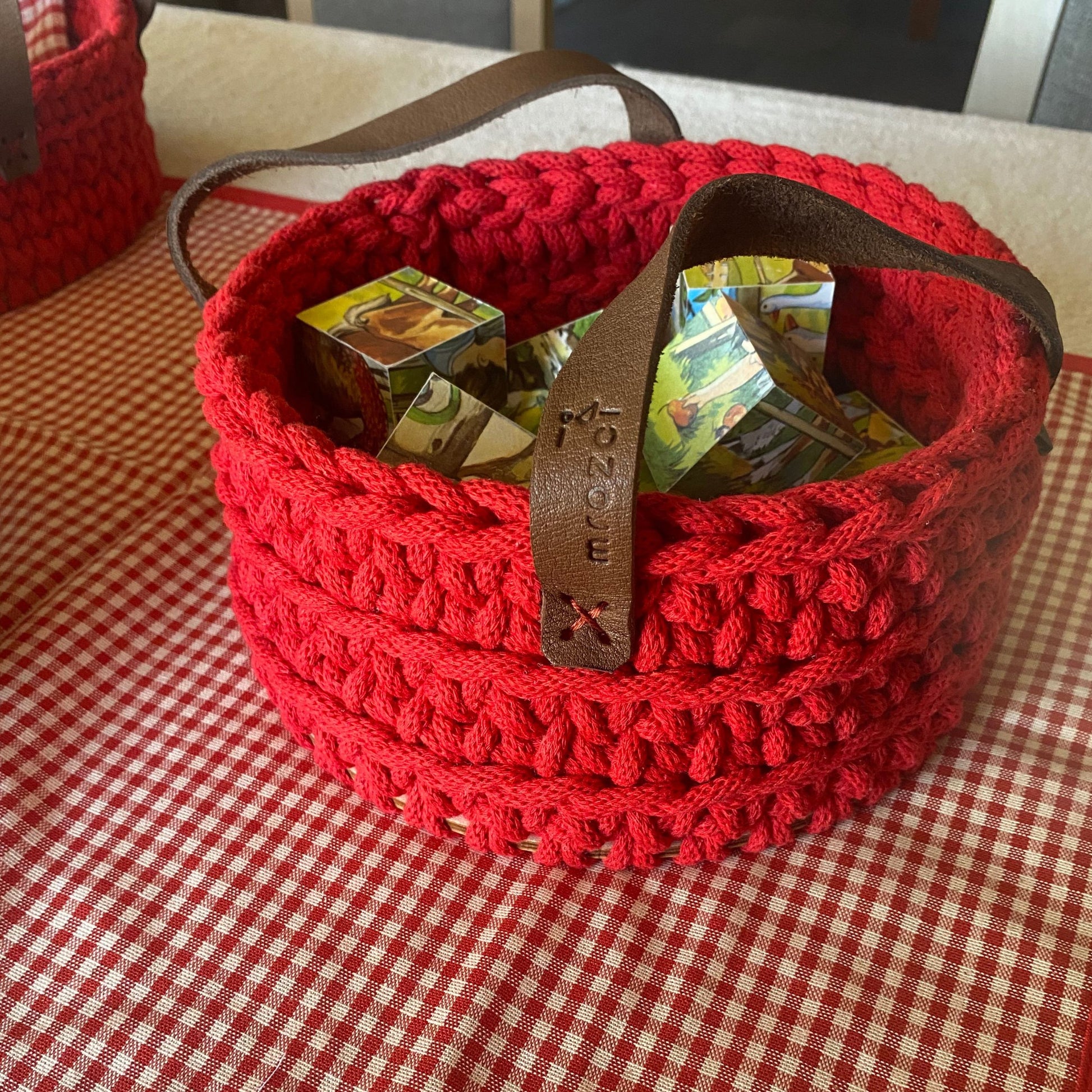 Handmade cotton cord basket, detail of leather handles